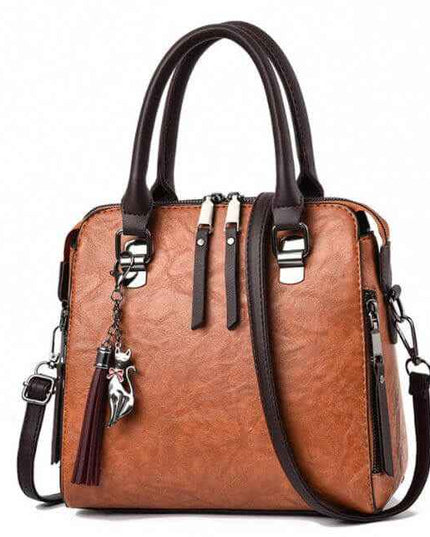 Ladies luxury handbag with soft surface, brown color, featuring zipper closure and adjustable strap.