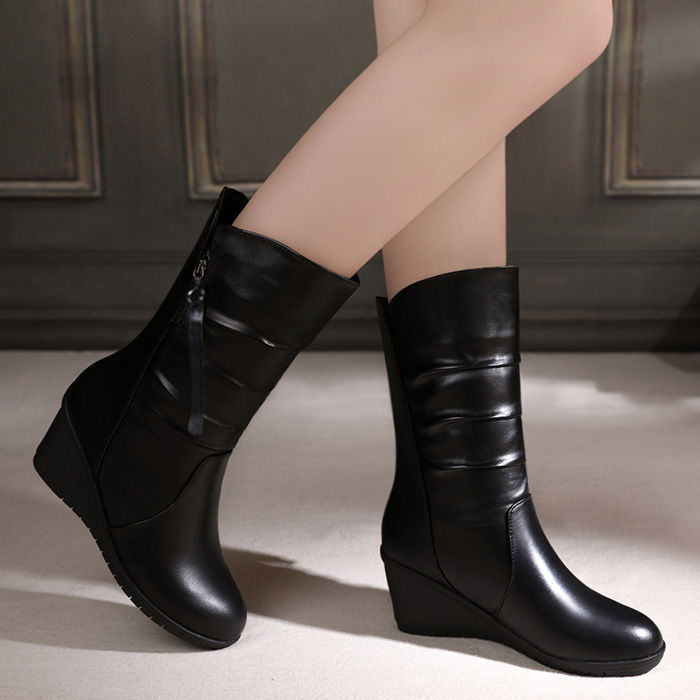 Women's black snow boots with side zipper and wedge heel, showcasing stylish and comfortable winter footwear.