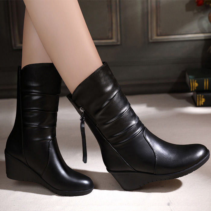 Women's black snow boots with plush medium leg, side zipper, and wedge heel for stylish winter wear.