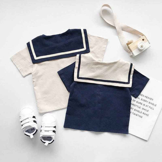 Boys and girls navy and beige short sleeve sets with matching sneakers.