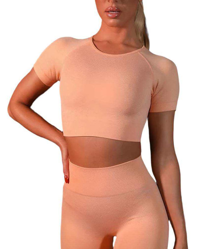 Seamless yoga sport leggings and short sleeve top set for women in peach color.