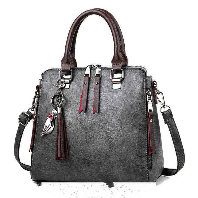 Luxury ladies handbag with crossbody strap, large soft surface, zipper opening, and PU lining.