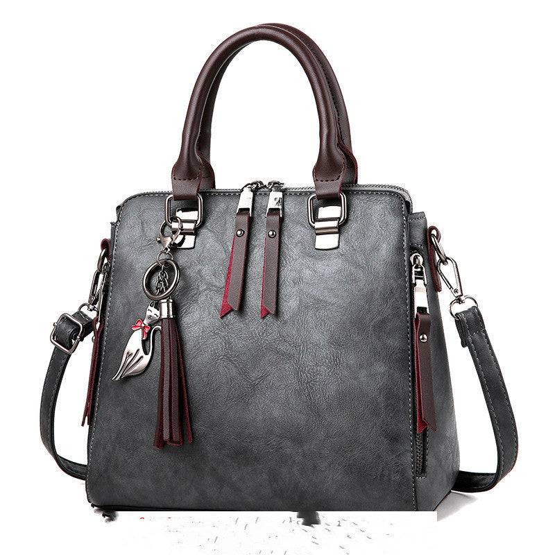 Luxury ladies handbag, crossbody bag with zipper, soft material, trendy design.