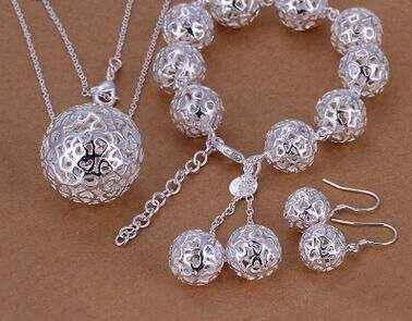 Silver-plated fine jewelry set with three-dimensional ball pendant, including a bracelet and earrings, showcasing geometric design.