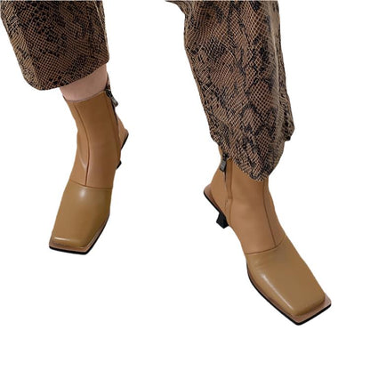 Fashion leather high-heeled Martin boots with side zipper and metal elements in apricot color.