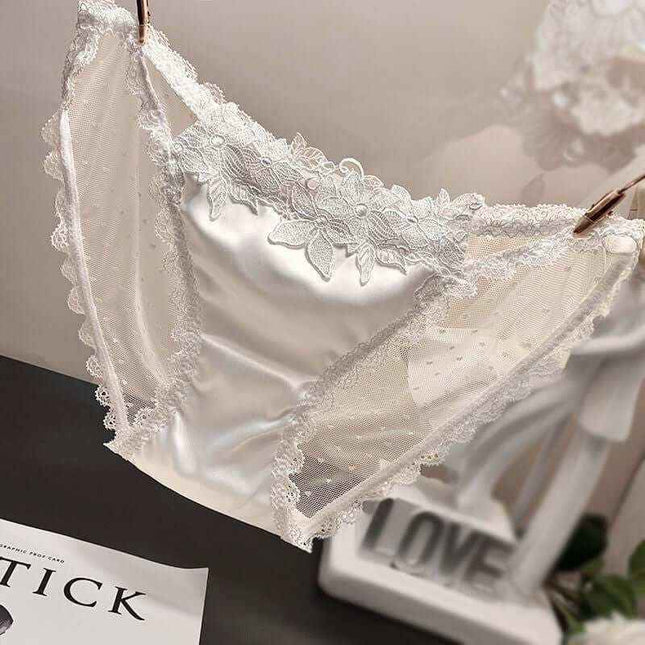 Women's mesh see-through low waist underwear in white lace design.