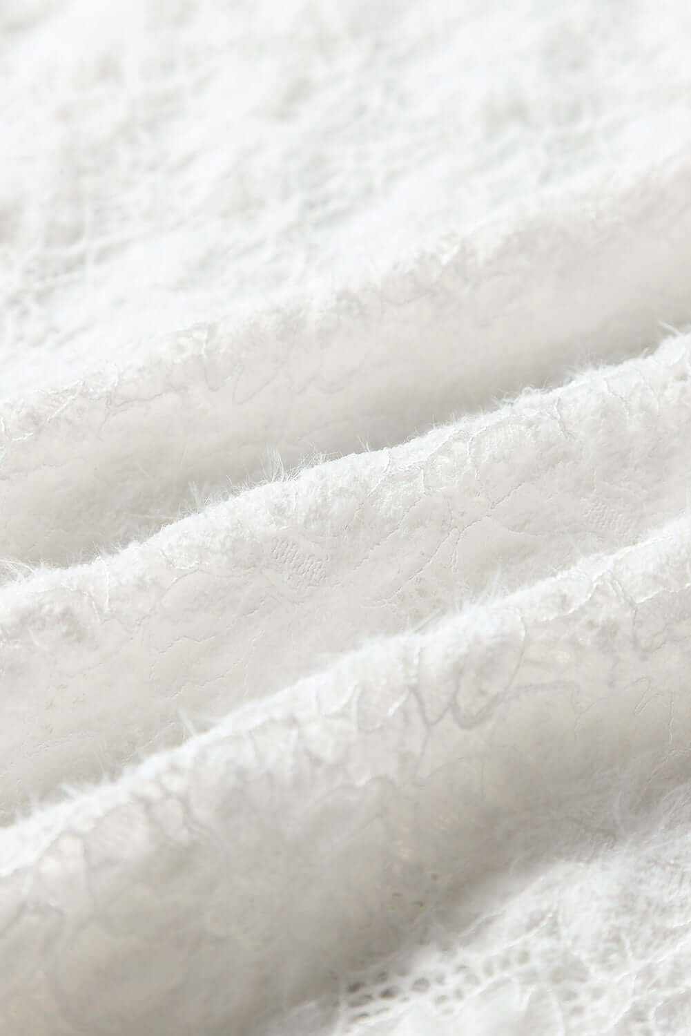 Mock Neck Long Sleeve Lace Top fabric detail showing semi-sheer white lace material.