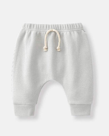 Boys' fashion simple waffle trousers with elastic waistband and cuffs.