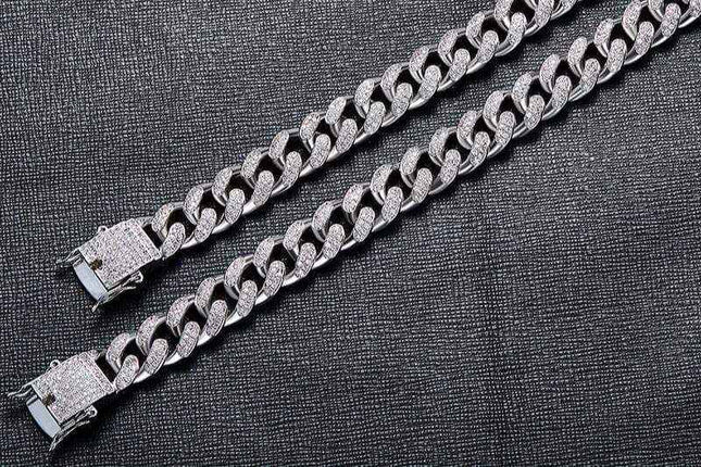 Men's Silver Cuban Link Bracelet with zircon accents on a dark background.