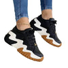 Women lace-up sports sneakers with black, white, and brown zigzag sole design.