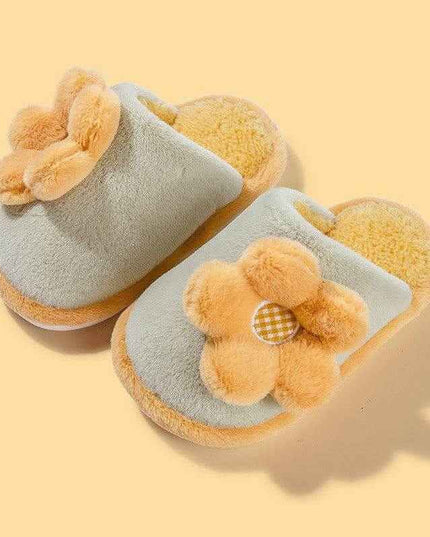 Cute yellow parent-child cartoon slippers with flower design on a soft cotton sole.