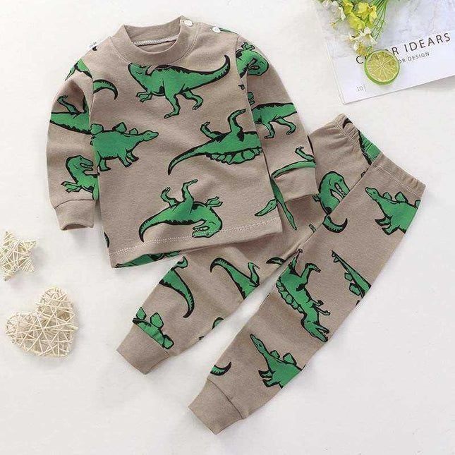 Children's cotton pajamas with green dinosaur print for boys and girls.