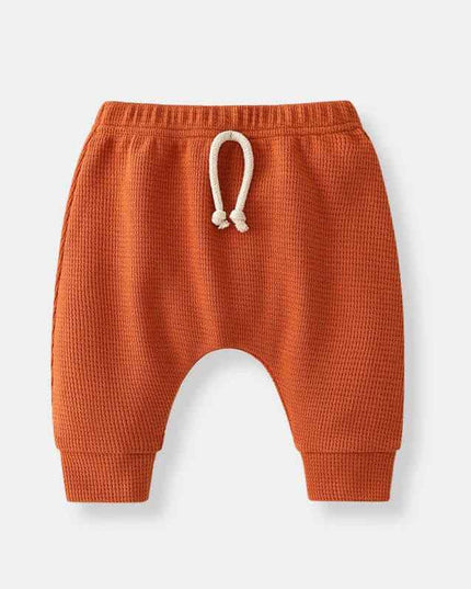 Boys' fashion simple waffle top trousers in orange with adjustable drawstring.