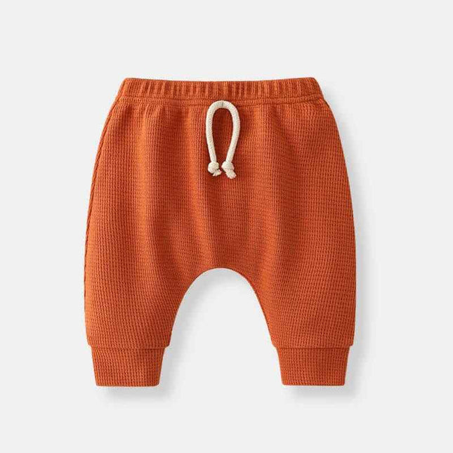 Boys' fashion simple waffle top trousers in orange with adjustable drawstring.