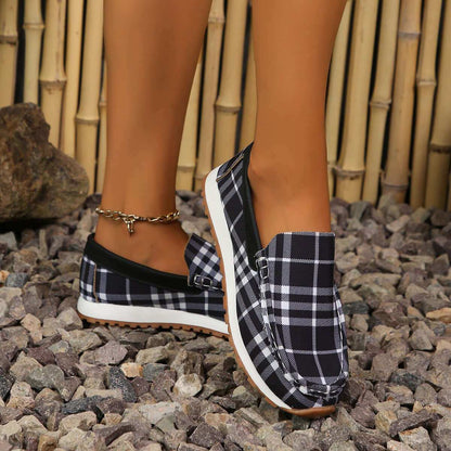 Plaid Round Toe Slip-Ons on rocky surface, offering comfort and style.