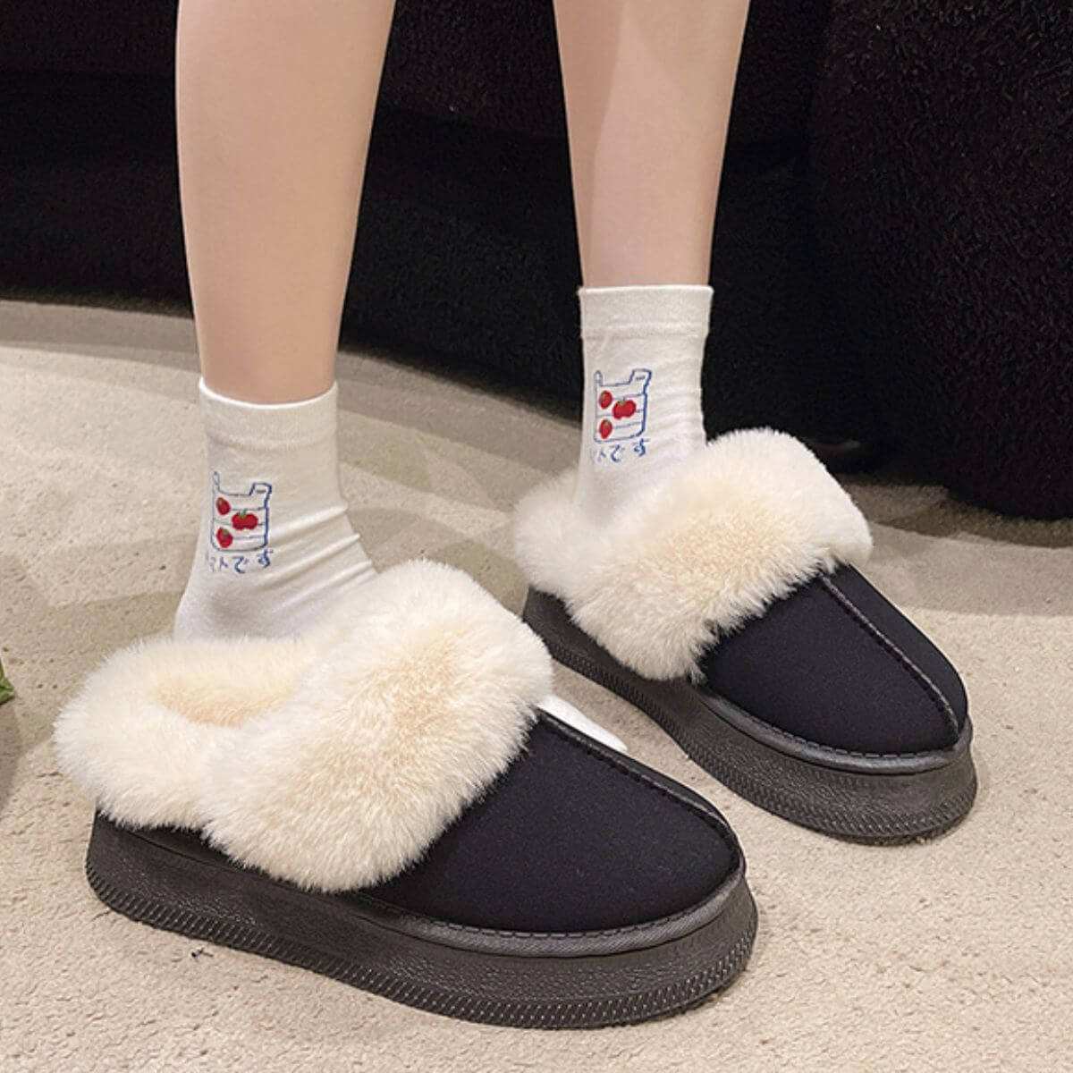 Suede Soft round toe platform slippers with faux fur trim and rubber sole.