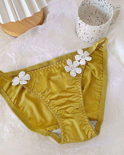 Pure Desire Underwear women's silky low waist briefs with embroidered floral decorations in yellow.