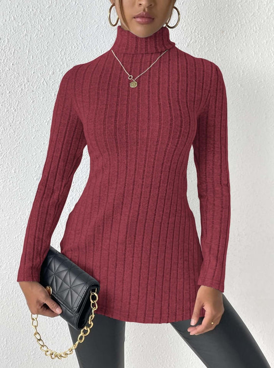 Women's turtleneck pullover sweater in red with ribbed texture, styled with a black quilted clutch.