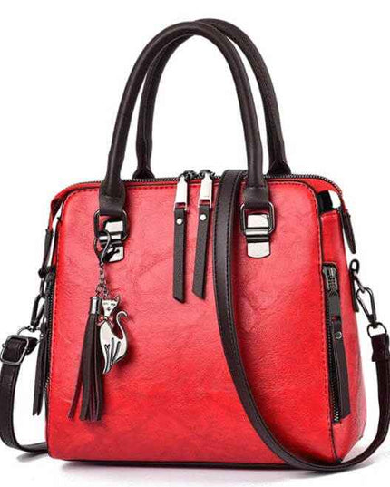 Ladies luxury handbag in red with black handles, featuring a zipper opening, sandwich zipper bag, and adjustable strap.