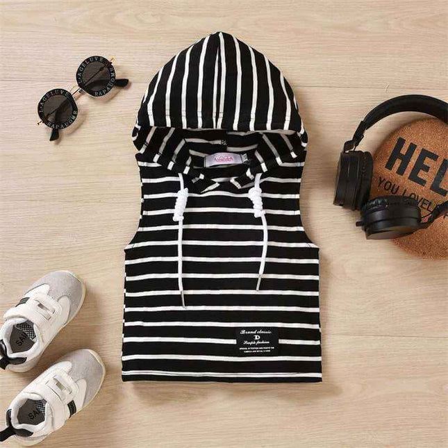 Boys' hooded striped tank top on wooden floor with sneakers and accessories.