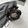 PU Leather Drawstring Shoulder Bag with essentials inside, small size, black color.