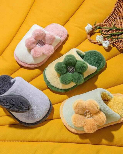 Parent-child cute cartoon indoor non-slip cotton slippers with floral design in various colors on a yellow background.