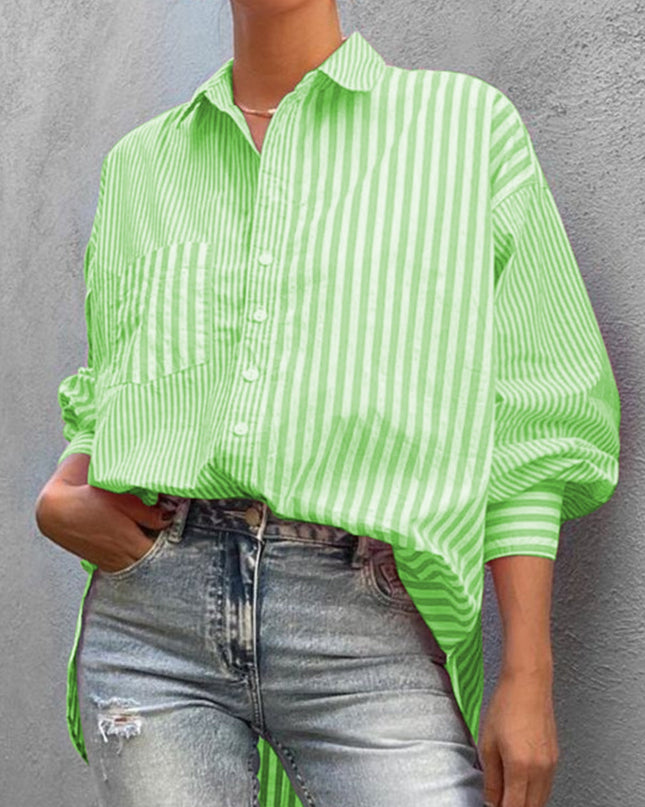 Striped button down long sleeve shirt in green and white worn with jeans.