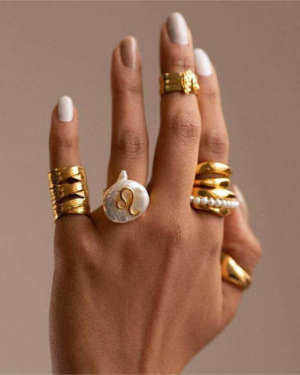 Cosmic Constellation Ring on hand with other gold jewelry.