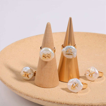 Cosmic Constellation Ring with zodiac symbols displayed on cones.