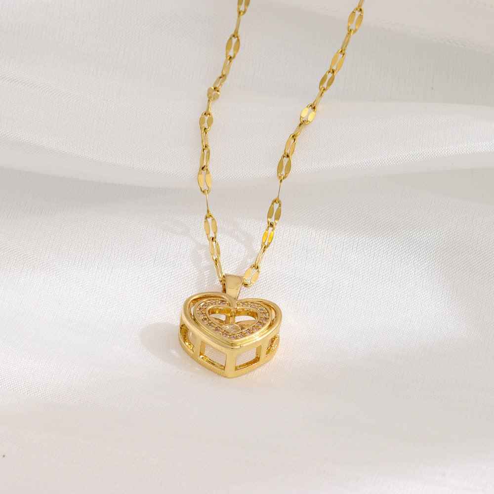 Double-layer gold chain necklace with heart-shaped pendant on a plush background.