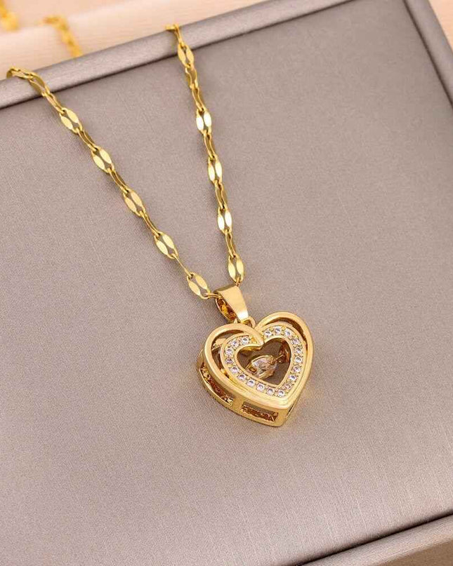 Gold chain with heart-shaped titanium steel pendant on display.