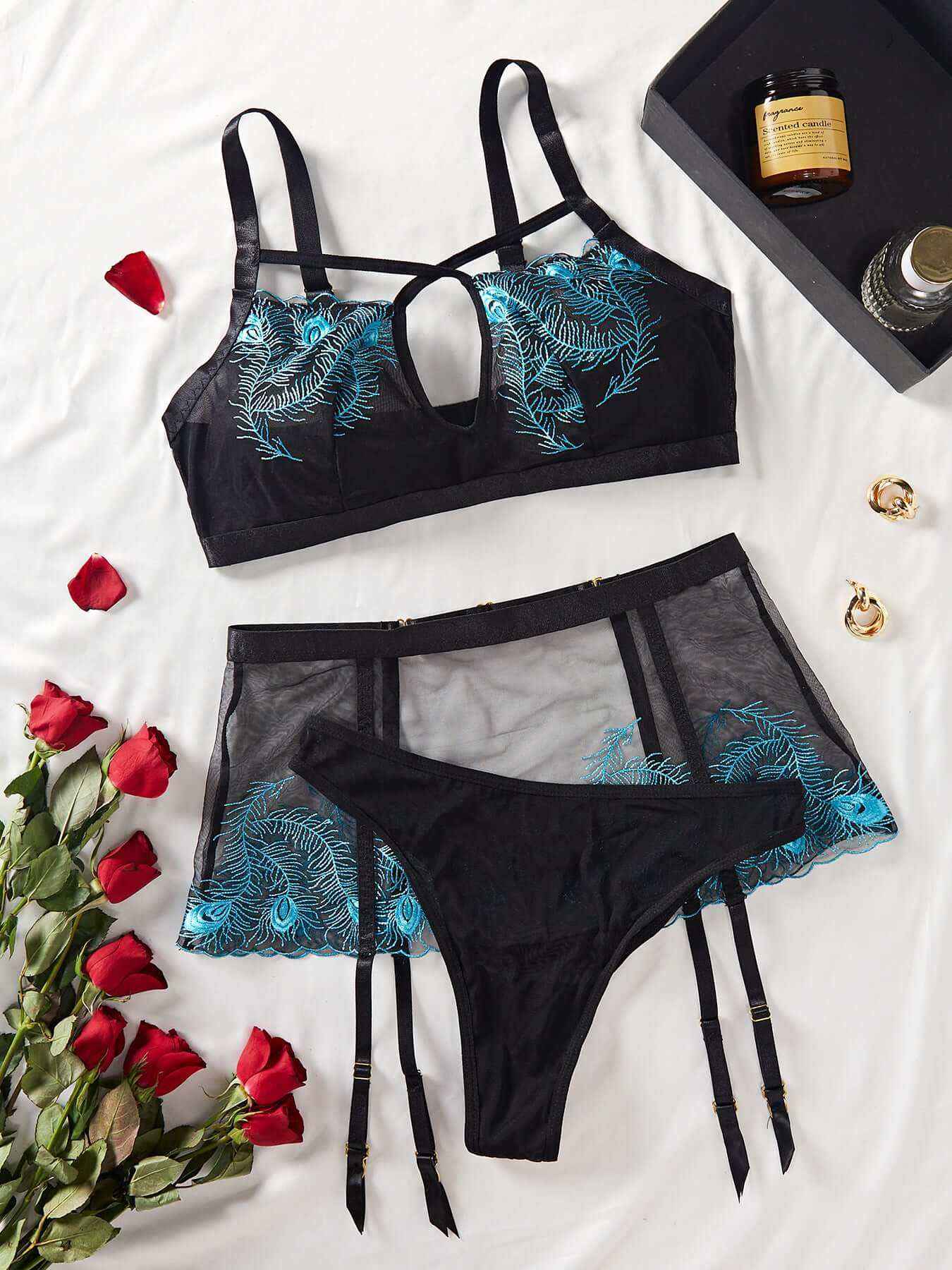 Three-piece black lingerie set with hollow-out design and blue floral accents.