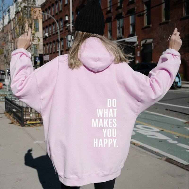 Loose sport hoodie with "Do What Makes You Happy" print in street-style setting.