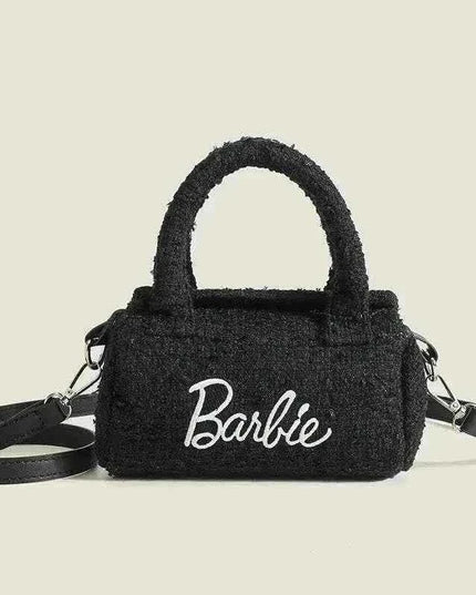 Women Fashion Pillow Barbie handbag in black cylindrical design with stylish handle.