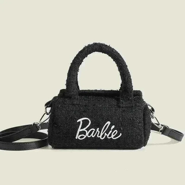 Women Fashion Pillow Barbie handbag in black cylindrical design with stylish handle.