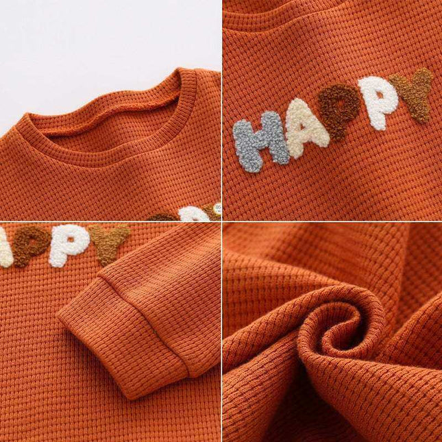 Boys' fashion simple waffle top with colorful text detail.