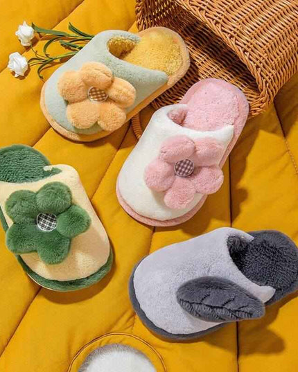 Cute cartoon parent-child non-slip cotton slippers with floral design in multiple colors on a yellow background.