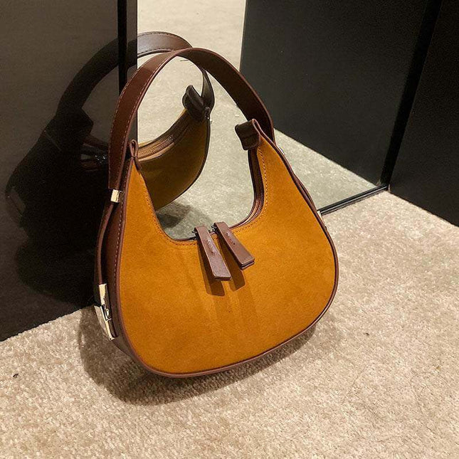 Fashion high-grade matte French minority handbag with a sleek design in brown, featuring a single shoulder strap and soft handle.