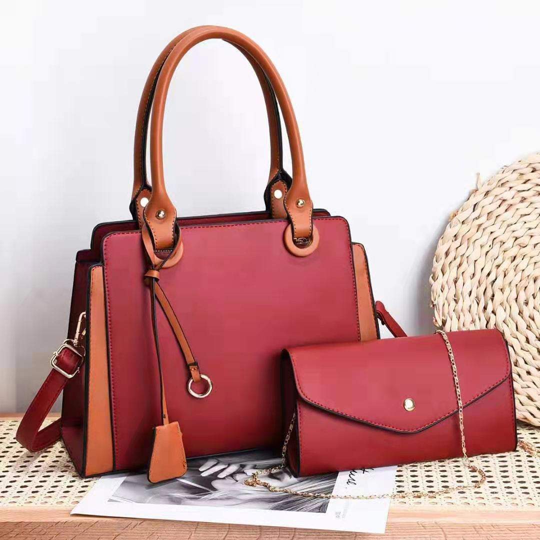 Trendy women's bags in red with matching handles and accented details.