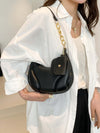 PU Leather Shoulder Bag with EarPods Bag, medium-sized, black, worn by a person in a white shirt.