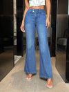 Woman wearing stylish bootcut jeans with pockets, showcasing a flattering fit and modern design.