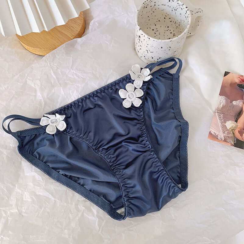 Silky embroidered floral decorations low waist briefs in blue on a stylish backdrop.