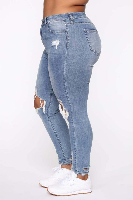 Stretch Ripped Women Plus Size Jeans with high waist and distressed details.