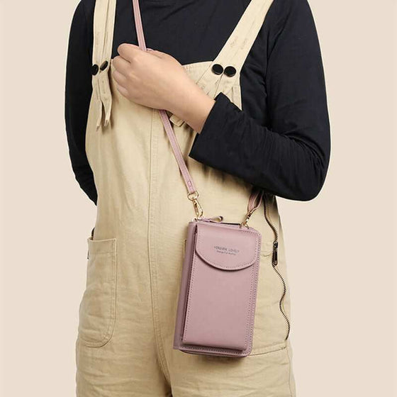 Women mobile phone crossbody large wallet shoulder bag in pink PU leather, worn stylishly across a casual outfit.