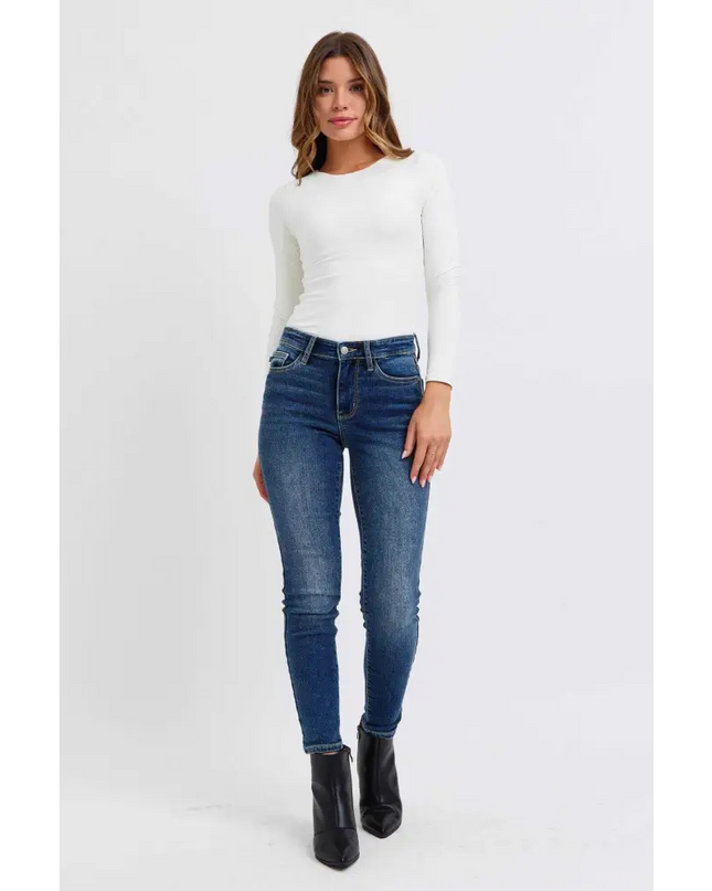 Woman in Judy Blue Blue Denim Skinny Jeans with stylish boots from Plush Fashion Shop